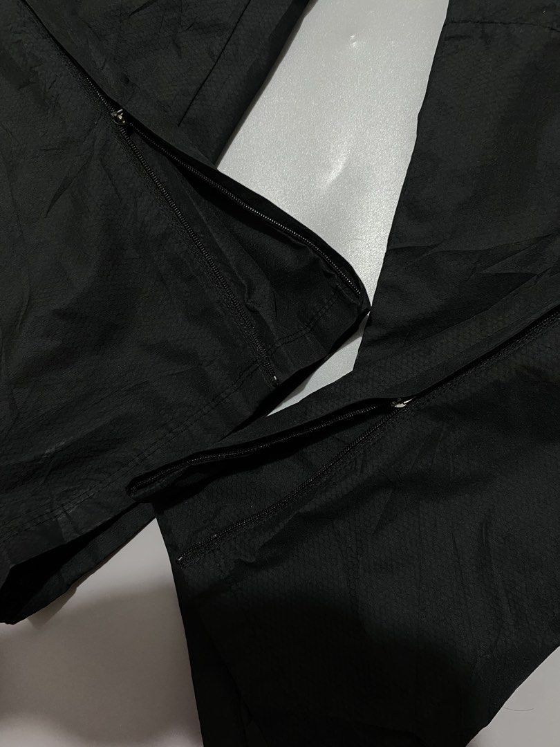 Nike Total 90 Black Track Pants (Category: Joggers) located in Manila. Submitted by urboycee (Listing ID 1469711280, Image 2). Description: - Brand: Nike Total 90 - Color: Black with orange accents - Size: Medium (M tag inside) - Features: Nike Fit Storm technology, adjustable drawstring waist, lower leg zippers - Branding: Printed T90 logo near waistband, small Swoosh and '90' graphic on front leg - Condition: Clean overall, well-maintained.