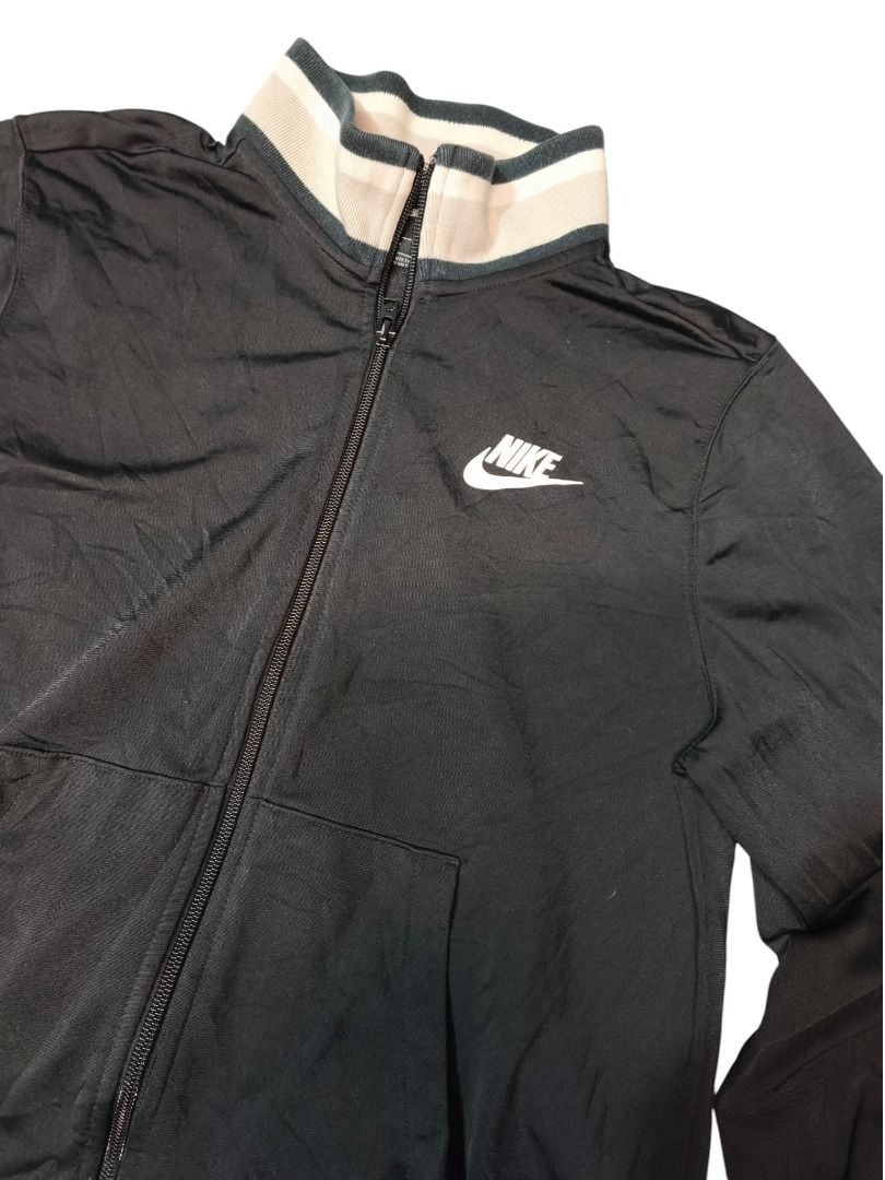 NIKE TRACK JACKET (Category: Activewear) located in Baguio. Submitted by boneteezandharmony (Listing ID 1469664638, Image 2). Description: Classic black Nike zip-up with cream striped collar and embroidered-style swoosh. Clean minimalist sportswear look. Condition: Good Size on tag: M Dimes: Approx. 18” width × 21” length.