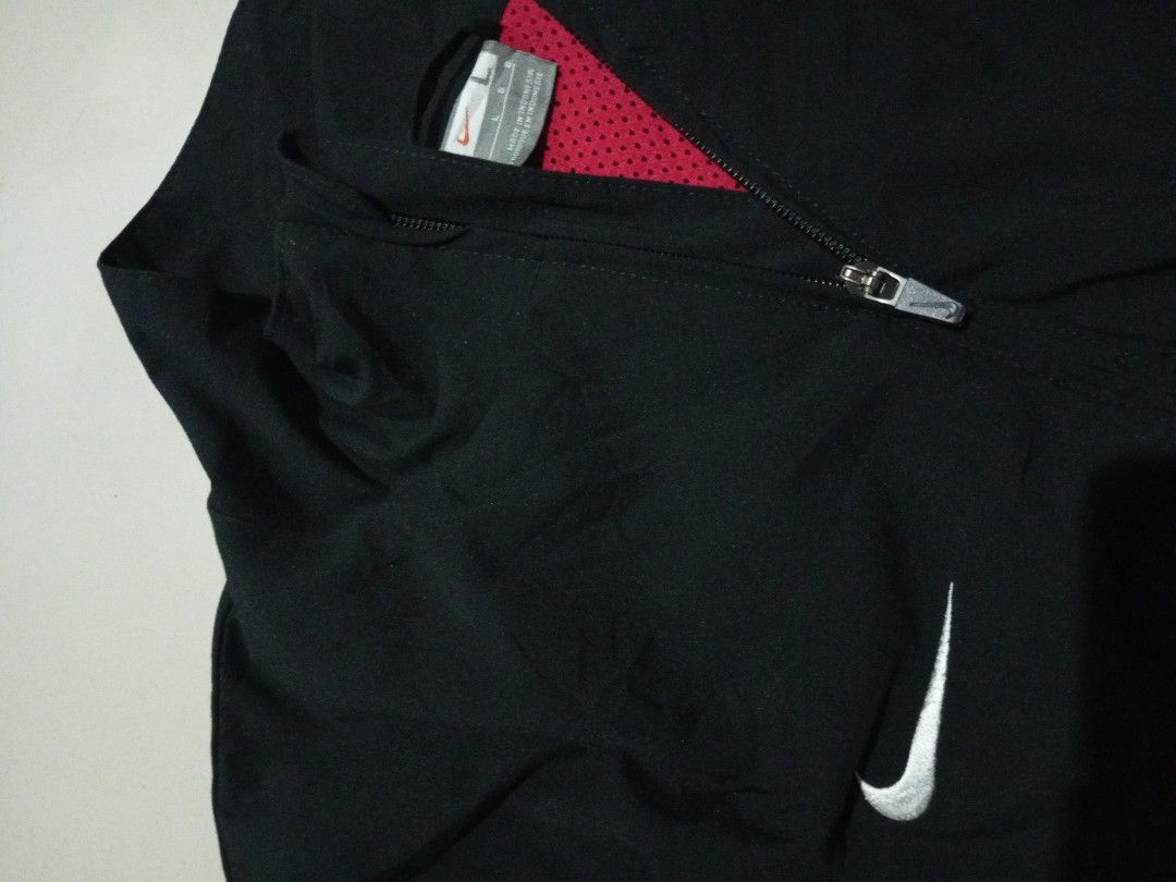 Nike Vintage Black and Red Zip Track Jacket (Category: Coats, Jackets and Outerwear) located in Bacolod City. Submitted by richjohn.958 (Listing ID 1469664554, Image 2). Description: - Brand: Nike - Style: Track jacket with full zip and stand collar - Colorway: Black and red colorblock - Details: Small embroidered Nike swoosh on the chest and additional logo on the left sleeve - Interior: Breathable red mesh lining - Size: Large - Origin: Made in