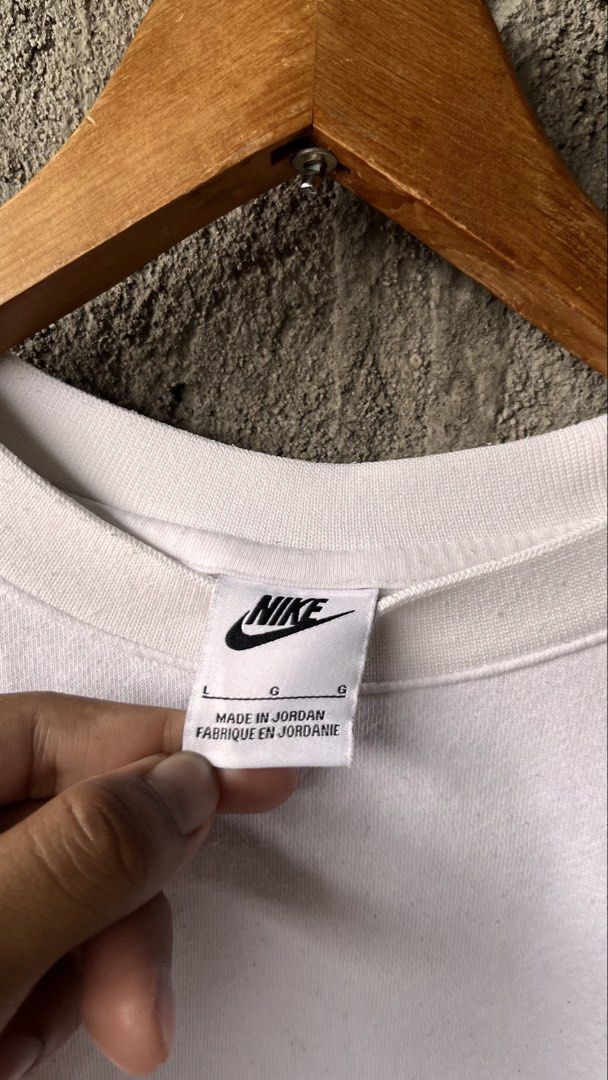 Nike White Brown Logo Embroidered Sweatshirt (Category: Coats, Jackets and Outerwear) located in Cabuyao City. Submitted by bulandos (Listing ID 1469581113, Image 2). Description: - Brand: Nike - Style: Crewneck sweatshirt with embroidered brown logo (Tag: BV2662-100) - Size: Large - Color: White - Material: 80% Cotton, 20% Polyester with cozy fleece interior lining - Origin: Made in Jordan - Fit: Classic fit, perfect for casual outfits.