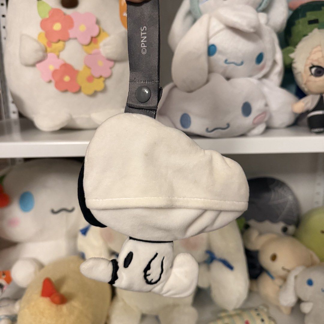 Niko and... x Snoopy Peanuts Pouch (Category: Plushies & Soft Toys) located in Taguig. Submitted by exidofficial (Listing ID 1469689533, Image 2). Description: - Authentic Niko x Peanuts collaboration Snoopy Pouch - Features Snoopy wearing stylish sunglasses and a collar - Soft and huggable black and white fabric construction - Includes a convenient grey strap with a snap button closure - Official Peanuts copyright printing on the strap - Perfect