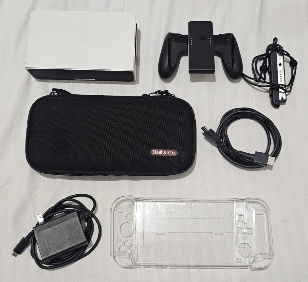 Nintendo Switch OLED Model White with Accessories and Carrying Case (Category: Nintendo) located in Quezon City. Submitted by radio_3000 (Listing ID 1469644744, Image 1). Description: For Sale : NSW OLED ACCESSORIES Switch Dock - 600 Joy-Con Grip and Wrist Strap - 450 Charger and HMDI Cable - 400 Skull & Co. EDC Case and Transparent Case - 450 Take All 1.5k sama ko na box Makati Area Ayala Triangle/Cash and Carry .