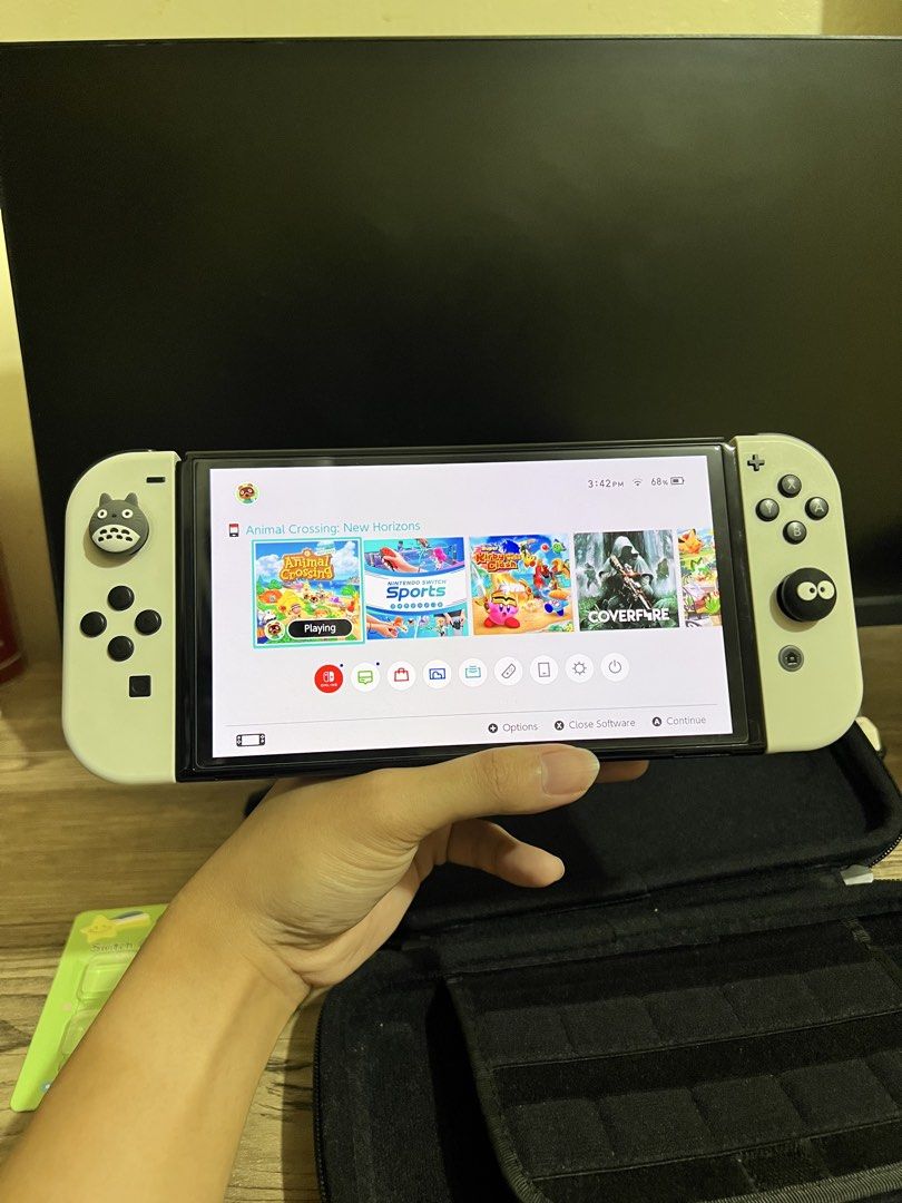 Nintendo Switch OLED No games (Category: Nintendo) located in San Jose del Monte. Submitted by seiji.notebook (Listing ID 1469755835, Image 2). Description: - Nintendo Switch OLED Model (White) - Clean screen and Joy-Cons, fully functional - Intact standard back stand and game slot - Includes black carrying case - Comes with adorable Totoro spare joystick caps - Extra transparent covers included for added protection -Dock, HDMI and charger all or