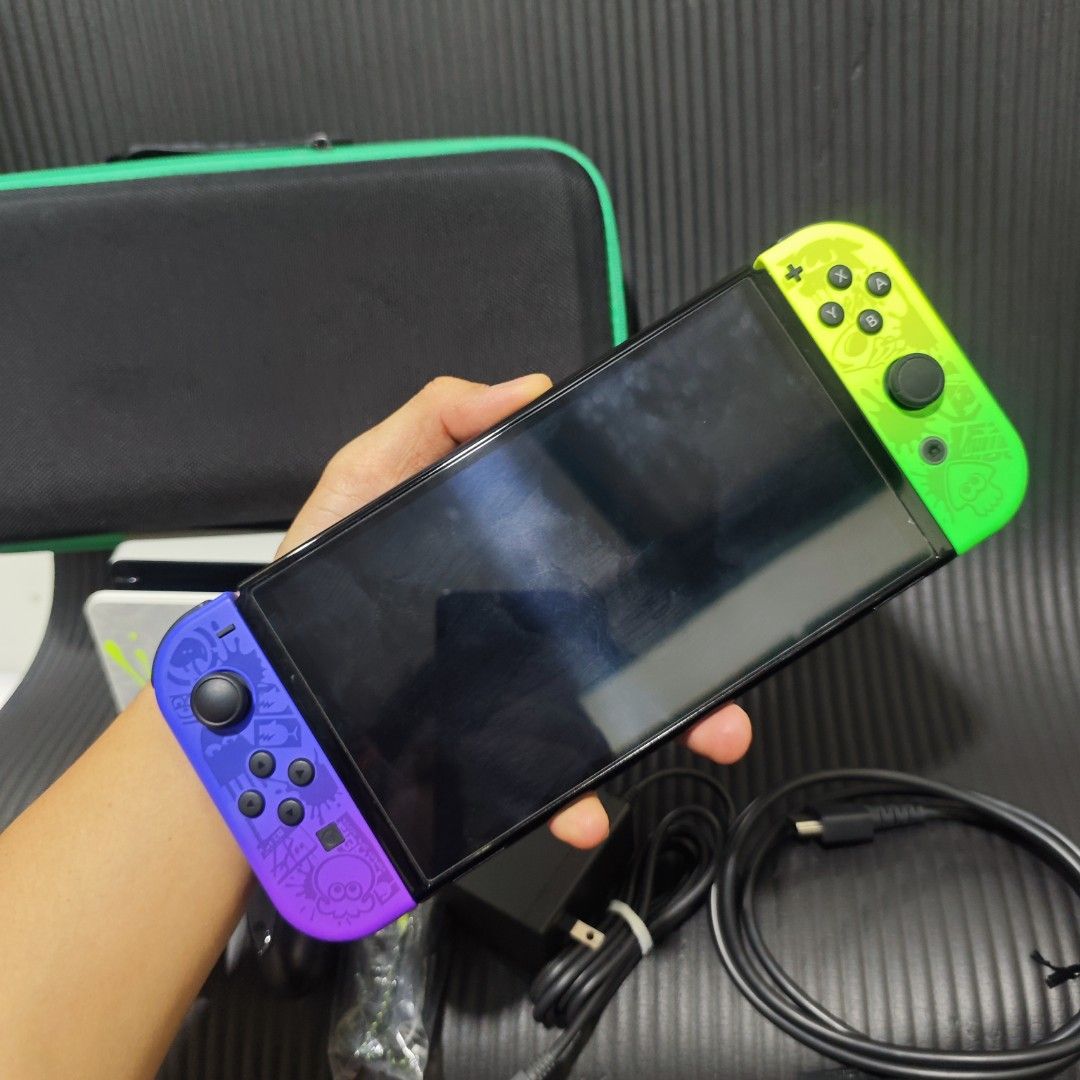 Nintendo Switch Oled Splatoon Edition Complete but no box (Category: Nintendo) located in Quezon City. Submitted by shopme_gadget30 (Listing ID 1469719499, Image 2). Description: kindly read the details 9/10 Superb Condition no issue excellent performance no drifting all buttons working no dents no scratches to minimal scratches but not noticeable with tempered glass since day 1 latest firmware non jb or not yet modded NO BOX inclusion Travel Bag