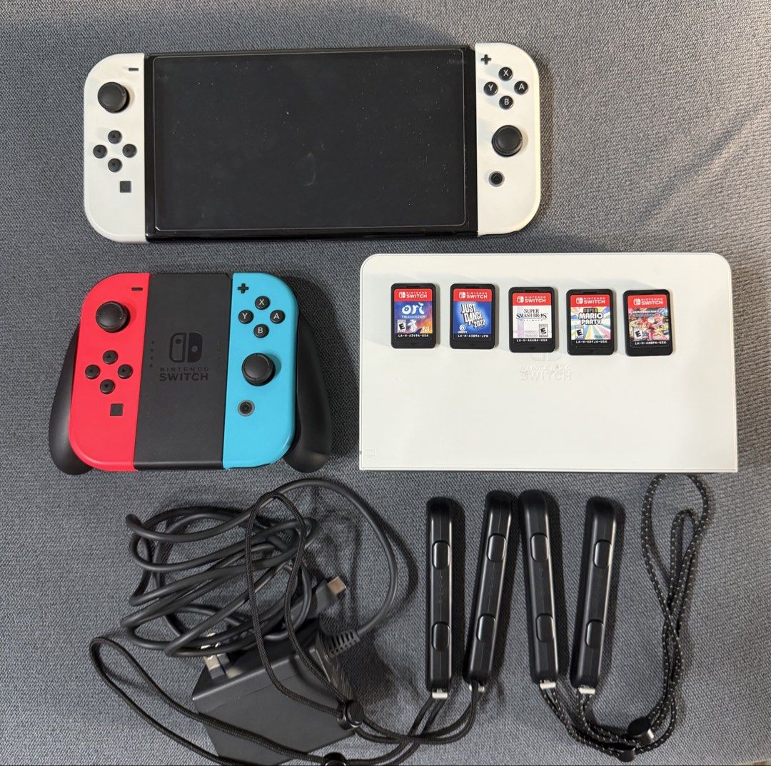 Nintendo Switch OLED White Bundle (Category: Nintendo) located in Caloocan City. Submitted by wtalent (Listing ID 1469581406, Image 1). Description: For Sale: Nintendo Switch OLED White (Rarely Used - Never Jailbroken, No Issues, Complete Original Set) Games Included: 1. Super Smash Bros 2. Super Mario Party 3. Mario Kart 8 4. Ori 5. Just Dance 2022 Accessories: 1. Extra Joycon pair (no stickdrift) 2. Tempered Glass (installed) 3. Dobe Case 4. Si