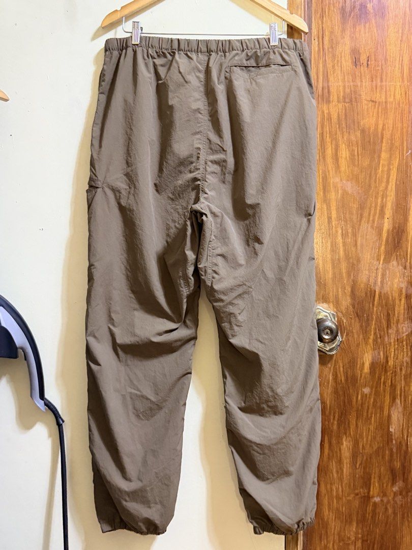 Nylon Casual Pants Brown Size XL (Category: Trousers) located in Paete. Submitted by skydruemadison (Listing ID 1469604728, Image 2). Description: - Size: XL - Color: Brown - Material: Lightweight nylon - Waist: Elastic with built-in adjustable strap and buckle closure - Fit: Relaxed through the legs with tapered ankles - Pocket: One back pocket - Condition: Excellent, clean with no stains or tears - Perfect for: Outdoor activities or daily loung