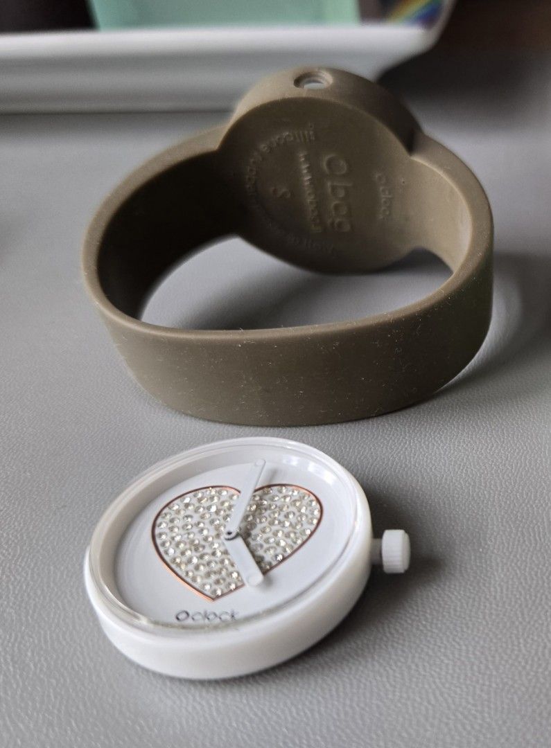 Obag Watch (Category: Women's Watches) located in Quezon City. Submitted by mgdeclutters (Listing ID 1469633914, Image 2). Description: - Brand: O bag (O clock) - Size: S (Small) - Strap: Brown/Taupe silicone rubber band - Dial: White face with crystal rhinestone-filled heart design - Interchangeable pop-out watch dial design - Condition: Good pre-owned condition as shown in photos.