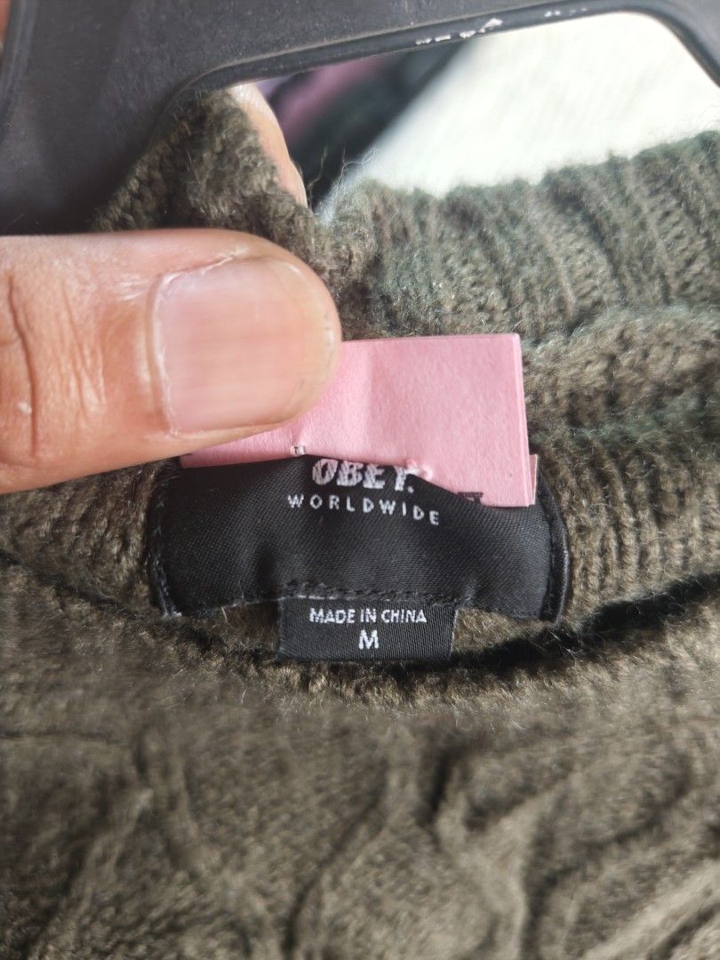 Obey Worldwide Green Cable Knit Sweater Size M (Category: Longsleeves) located in Isulan. Submitted by jaysthrift (Listing ID 1469753321, Image 2). Description: - Brand/Model: Obey Worldwide Sweater - Color: Army Green - Size: Medium (M) - Material: 90% Acrylic, 10% Wool (Made in China) - Design: Classic crewneck with textured cable knit pattern - Features: Thick, warm construction with ribbed collar, cuffs, and hem.