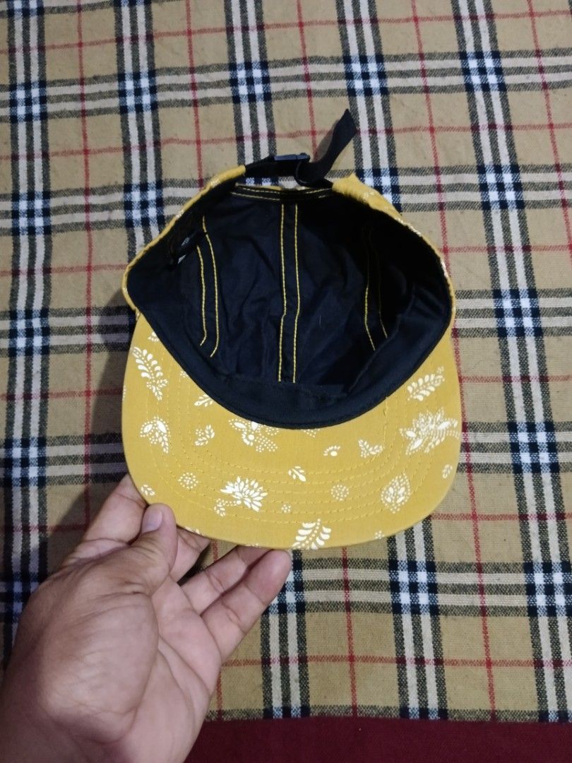 Obey Yellow Bandana Print 5-Panel Cap (Category: Caps & Hats) located in General Santos City (Dadiangas). Submitted by freehorse.5f2a61 (Listing ID 1469629708, Image 3). Description: - Brand: Obey - Style: 5-panel cap - Color/Pattern: Mustard yellow with white floral bandana print - Details: Brown stitched Obey logo patch on the front - Back Closure: Adjustable black nylon strapback with plastic buckle - Interior: Black fabric lining with yellow 