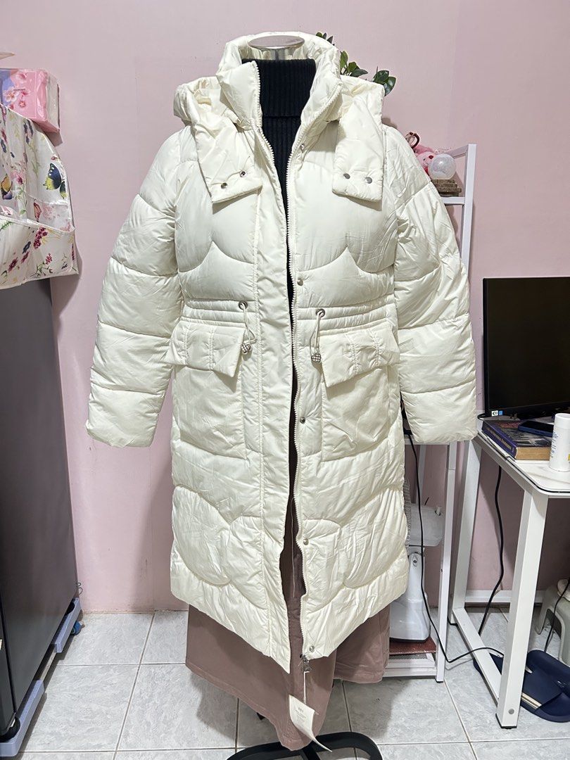 Off White Hooded Long Puffer Jacket Size XL on tag (Category: Coats, Jackets and Outerwear) located in Makati City. Submitted by aizy_sell (Listing ID 1469604667, Image 1). Description: - Condition: Brand new with tags (never worn - Size: XL - Color: off White - Style: Long puffer jacket with quilted design and hood - Features: Front zipper closure, front pockets, and cute heart-shaped hardware on drawstrings - Perfect for cold weather.