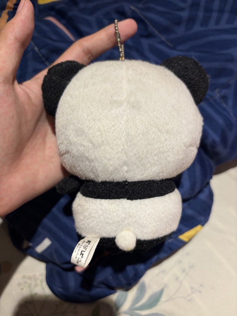 Ojisan Panda plush keychain with glasses (Category: Plushies & Soft Toys) located in Makati City. Submitted by squishycorner (Listing ID 1469714380, Image 2). Description: - Adorable Ojisan Panda design wearing glasses and a blue tie - Made with ultra-soft, huggable fabric - Equipped with a sturdy silver ball chain for easy hanging - Features a small tag at the back - Perfect cute accessory for your bags, backpacks, or keys.