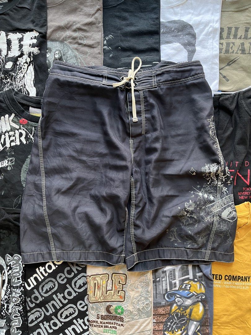Old Navy Black Board Shorts Surf Trunks (Category: Swim Trunks & Board Shorts) located in Baao. Submitted by plainclothesdept (Listing ID 1469696907, Image 1). Description: y2k grunge boardshorts waist - 32-34 in. length - 22 in. hem - 12 in. no flaws - Brand: Old Navy - Color: Dark charcoal black with white contrast stitching - Closure: Drawstring waist with grommets and velcro fly - Pockets: One back pocket with velcro flap and drainage eyelets