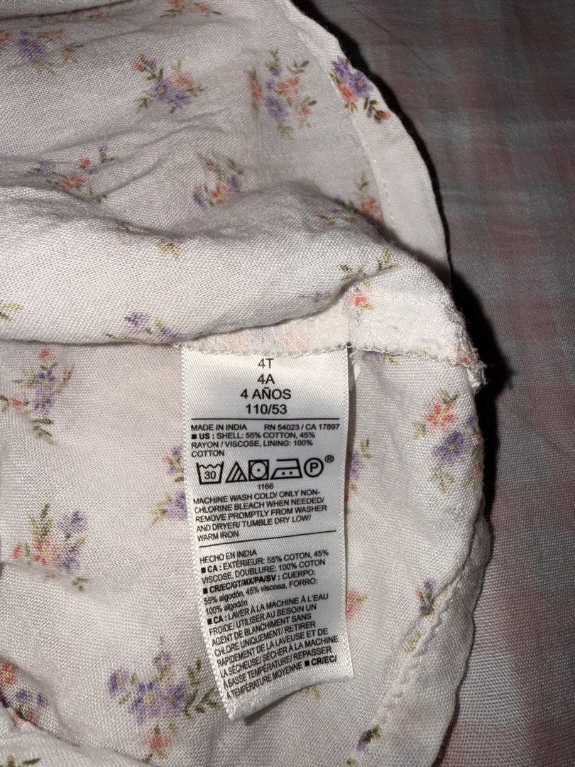Old Navy Floral Ruffle Skort Size 4T (Category: Babies & Kids Fashion) located in Marikina City. Submitted by mvmaggie (Listing ID 1469587084, Image 3). Description: - Brand: Old Navy - Size: 4T - Design: White with small purple and pink floral print - Features: Easy elastic waistband, built-in shorts, and layered ruffle skirt design - Material: Shell (55% cotton, 45% rayon), Lining (100% cotton) - Care: Machine washable - Condition: Great for pl