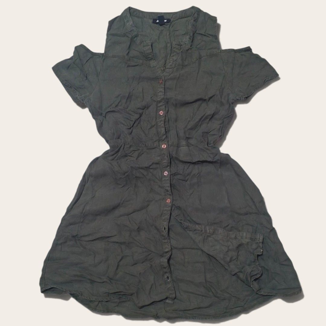Olive green cold shoulder button-down dress (Category: Dresses) located in Indang. Submitted by shanlennon09 (Listing ID 1469623122, Image 1). Description: - Color: Olive green - Style: Casual everyday dress with short sleeves and cold shoulder cutouts - Closure: Front button-down with matching buttons - Fit: Cinched waist with a relaxed flared skirt and high-low hemline - Material: Lightweight and breathable, ideal for warm weather.