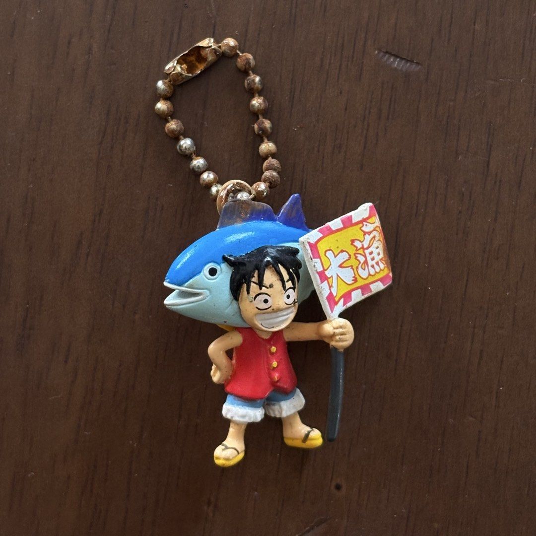 One Piece Anime Figures and Keychains Lot (Category: Figurines & Statues) located in Manila. Submitted by aobacafe (Listing ID 1469679262, Image 2). Description: - Lot of 4 One Piece miniature collectibles - Includes Tony Tony Chopper strap charm, Monkey D. Luffy fish costume keychain, Nami mini figure, and a silver armor knight figure - Condition: Shows paint wear, scuffs, and aging from storage - Ideal for desk decor or starting a small collect