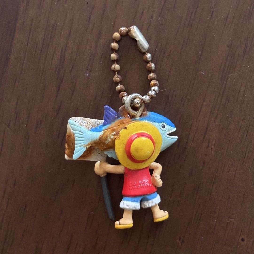 One Piece Anime Figures and Keychains Lot (Category: Figurines & Statues) located in Manila. Submitted by aobacafe (Listing ID 1469679262, Image 3). Description: - Lot of 4 One Piece miniature collectibles - Includes Tony Tony Chopper strap charm, Monkey D. Luffy fish costume keychain, Nami mini figure, and a silver armor knight figure - Condition: Shows paint wear, scuffs, and aging from storage - Ideal for desk decor or starting a small collect