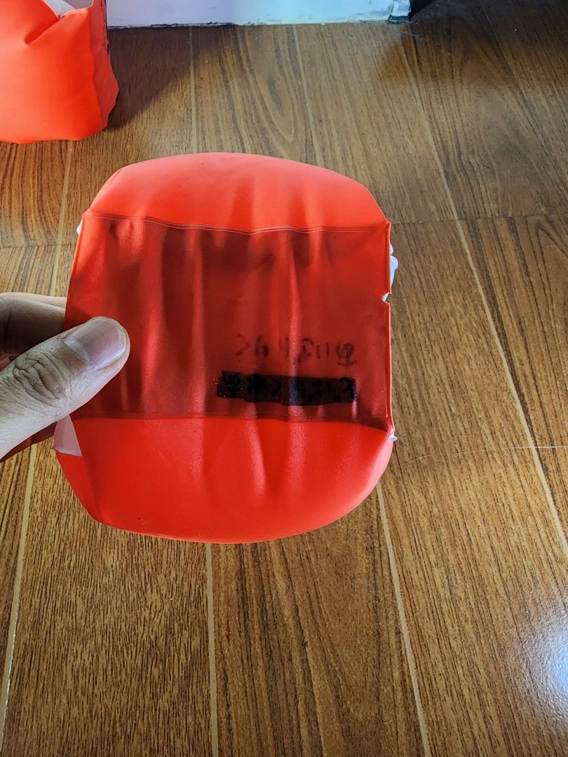 Orange Inflatable Swimming Arm Bands Floaties (Category: Water Sports) located in Meycauayan. Submitted by MP_Shop (Listing ID 1469587996, Image 2). Description: - Pair of orange inflatable arm bands for pool and beach use - Air valves are fully functional with no leaks - Shows normal signs of previous usage - Note: There is Japanese text written in permanent marker on one of the floaties - Affordable and ready for more fun in the water!.