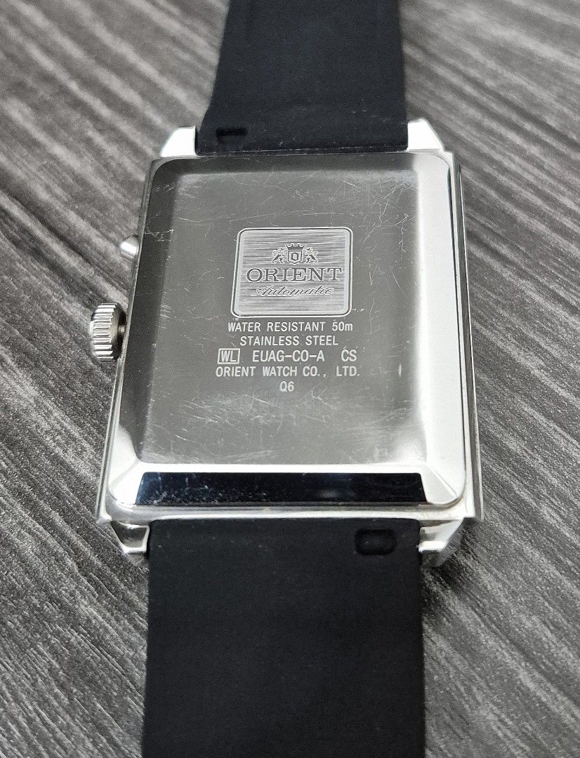 Orient Automatic Multi-Year Calendar Rectangular Watch (Category: Watches) located in Kuala Lumpur. Submitted by douglascar (Listing ID 1466322505, Image 2). Description: - Brand: Orient Automatic Watch - Dial: Textured white dial with unique multi-year calendar complication - Case: Rectangular stainless steel case (Note: Noticeable scratches on the case back) - Strap: Comfortable black rubber strap - Features: Date window at the 4 o'clock positi
