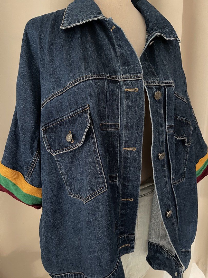 Oversized Denim Jacket with Striped Sleeves (Category: Coats, Jackets and Outerwear) located in Cainta. Submitted by zlove111 (Listing ID 1469619325, Image 2). Description: - Style: Oversized relaxed cut dark wash denim jacket - Sleeves: Short sleeves with eye-catching yellow, green, and red stripes at the cuffs - Closure & Collar: Button-up front with classic lapel collar - Pockets: Two functional chest flap pockets with button closure - Materia