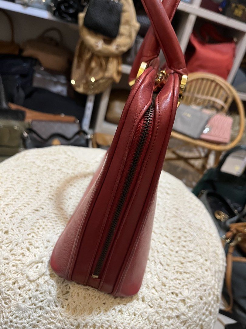 Paco Rabanne Red Leather Handbag (Category: Luxury Bags & Wallets) located in Bacolod City. Submitted by vintage_vogue6100 (Listing ID 1469672489, Image 3). Description: - Brand: Paco Rabanne - Material: Premium red textured leather - Hardware: Gold-tone with hanging metal charm tag on a beaded chain - Closure: Secure zip top - Handles: Dual structured top handles - Compartment: Interior storage for daily essentials - Measurements: 33cm (L) x 22c