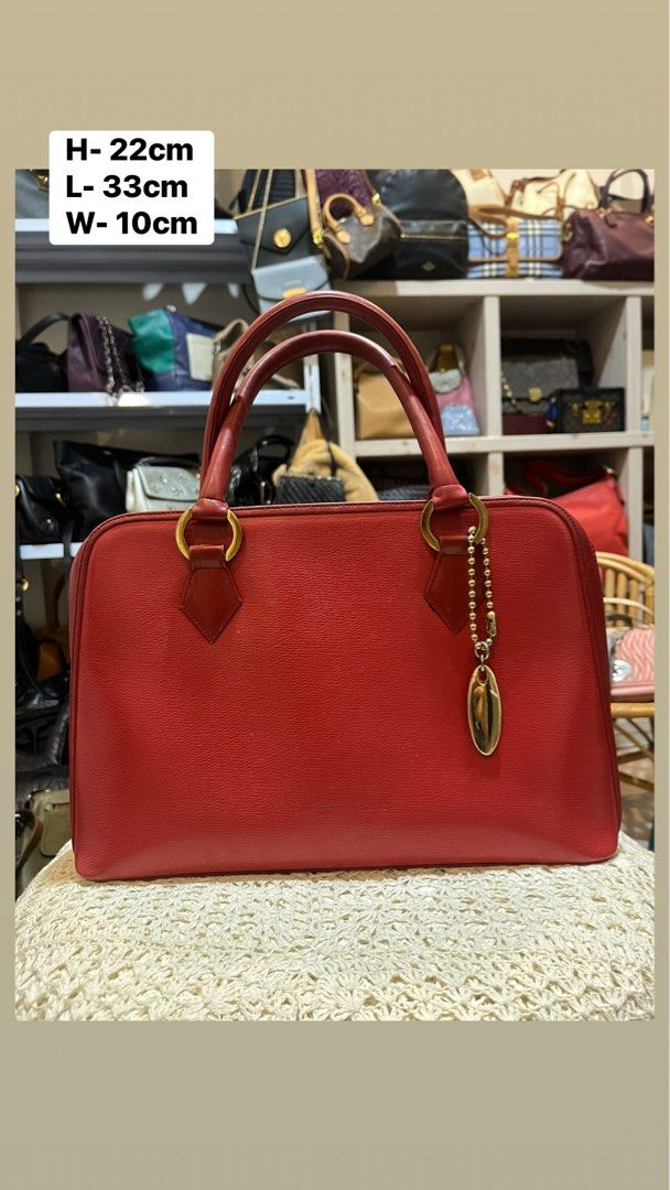 Paco Rabanne Red Leather Handbag (Category: Luxury Bags & Wallets) located in Bacolod City. Submitted by vintage_vogue6100 (Listing ID 1469672489, Image 1). Description: - Brand: Paco Rabanne - Material: Premium red textured leather - Hardware: Gold-tone with hanging metal charm tag on a beaded chain - Closure: Secure zip top - Handles: Dual structured top handles - Compartment: Interior storage for daily essentials - Measurements: 33cm (L) x 22c