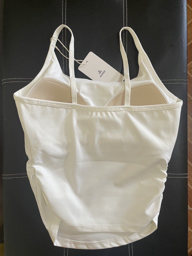 Active Padded Ruffled Tank Top (Category: Activewear) located in Manila. Submitted by deniiish (Listing ID 1469605701, Image 3). Description: - Condition: Brand new with tag - Color: White - Design: Tank top with double strap and waist-cinching - Material: Polyester/Spandex - Brand: FUYOGI - Ideal for: Workouts, yoga, or casual everyday wear.