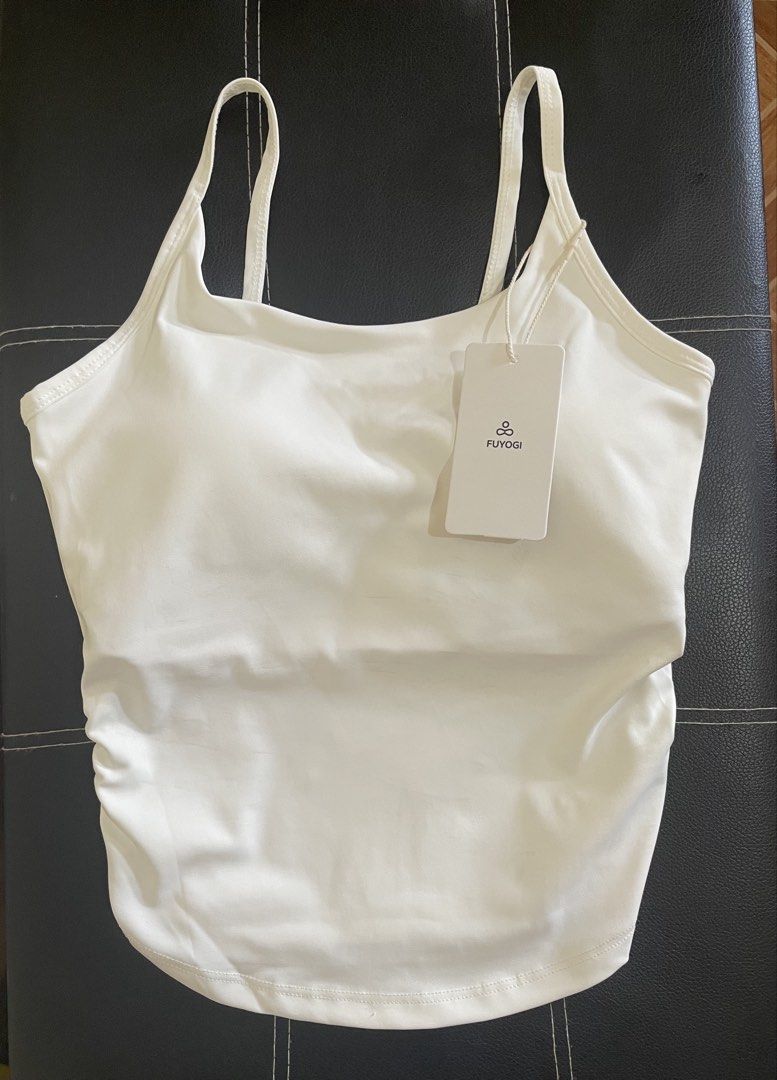 Active Padded Ruffled Tank Top (Category: Activewear) located in Manila. Submitted by deniiish (Listing ID 1469605701, Image 1). Description: - Condition: Brand new with tag - Color: White - Design: Tank top with double strap and waist-cinching - Material: Polyester/Spandex - Brand: FUYOGI - Ideal for: Workouts, yoga, or casual everyday wear.