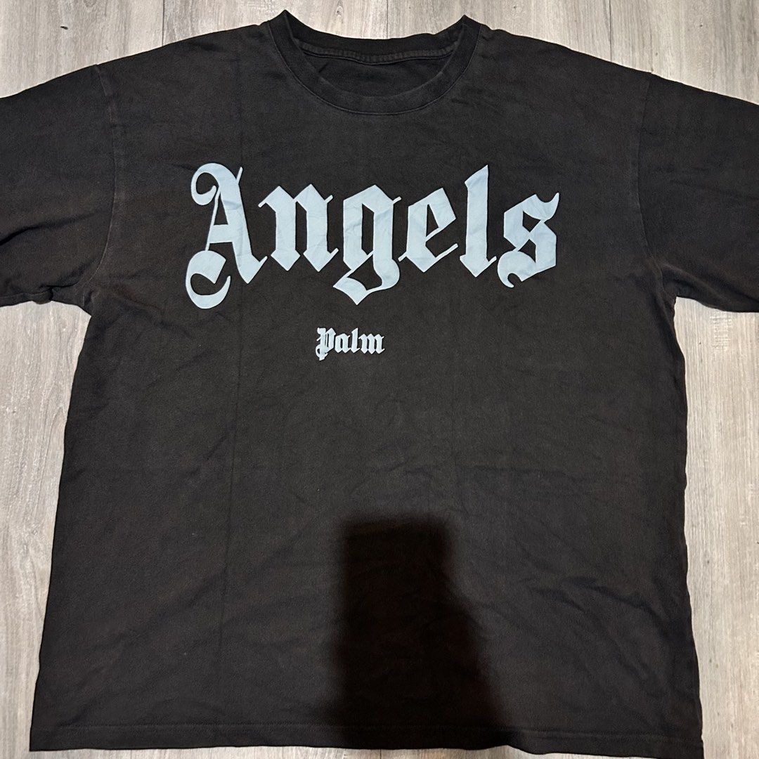 Palm Angels Black Tee (Category: Tshirts & Polo Shirts ) located in Marikina City. Submitted by paolody (Listing ID 1469659362, Image 1). Description: - Authentic Palm Angels t-shirt in washed black - Size: Medium (tag attached) - Design: Large gothic script logo across the chest - Fit: Relaxed fit with short sleeves and classic crew neckline - Condition: Clean overall with crisp, vibrant white print - Perfect for daily streetwear and casual fits