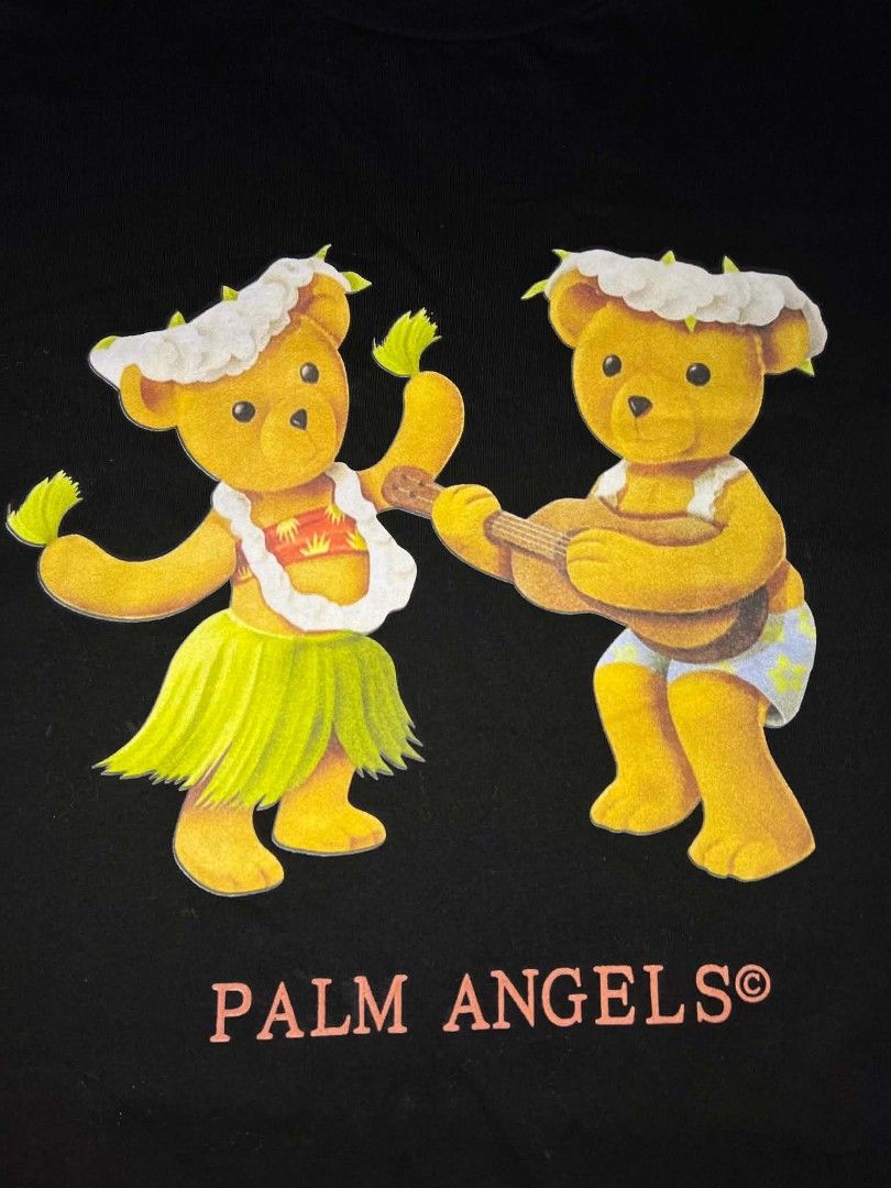 Palm Angels Hula Bears Black Tee Size S (Category: Shirts) located in Urdaneta. Submitted by jayceegarage (Listing ID 1469546479, Image 2). Description: Black cotton t-shirt from Palm Angels. Graphic print on the chest with two hula bears playing music. Pink Palm Angels logo underneath. Ribbed crew neck collar. Size small tag attached inside. Care and composition labels intact. with issue check last photo super visible issue unnoticeable po.