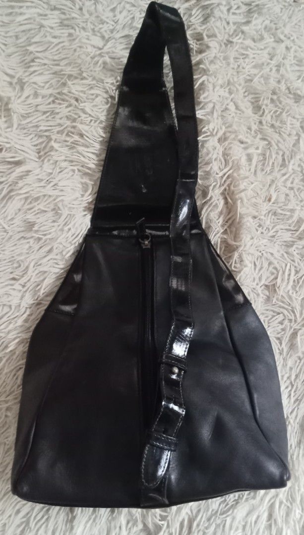 Paloma Picasso Black Leather Backpack Sling Bag (Category: Backpacks) located in Caloocan City. Submitted by noy5o1a (Listing ID 1469637076, Image 2). Description: - Brand: Paloma Picasso - Material: Combination of matte leather and glossy patent sections - Hardware: Distinctive silver-tone X emblem and interior metal plaque - Closure: Secure zip closure for the main compartment - Straps: Adjustable strap configuration - Design: Embossed signatur