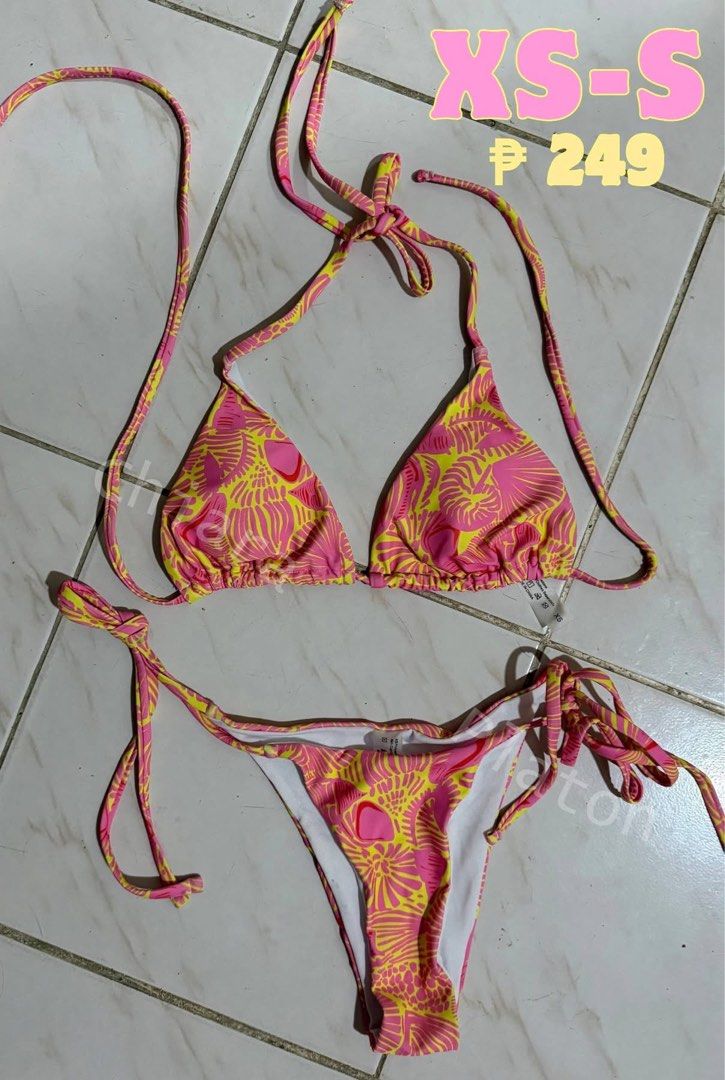 Pink and Yellow Patterned Two-Piece Bikini (Category: Bikinis & Swimsuits) located in Bacoor. Submitted by shyy10 (Listing ID 1469648399, Image 1). Description: - Pink and yellow tropical print two-piece bikini set - Triangle halter top with adjustable strings for a custom fit - Matching bottoms with side-tie closures - Fully lined inside with soft white fabric - Size: Fits XS to S - Condition: Brand new/Mint.