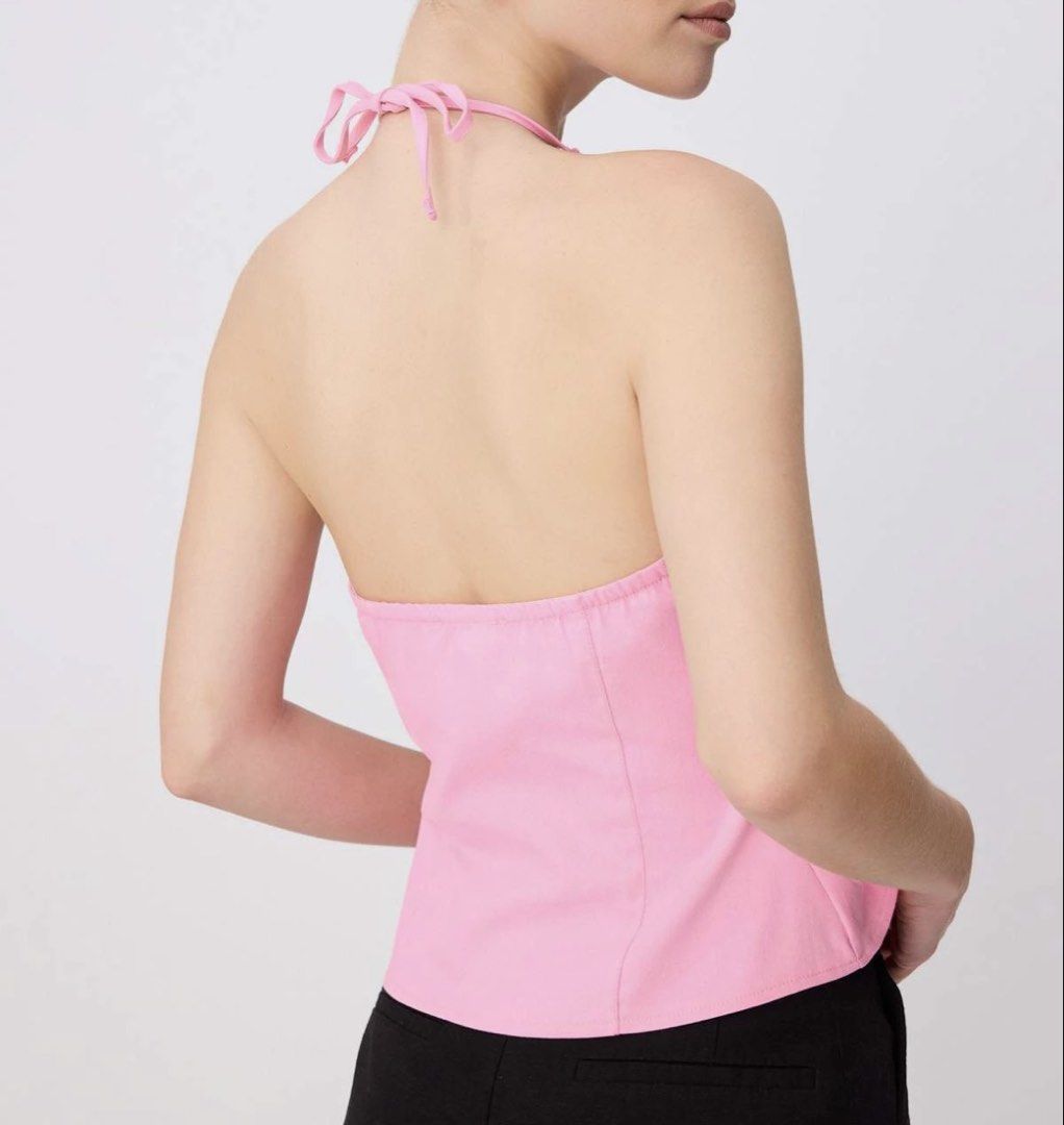 Pink Halter Neck Peplum Top (Category: Sleeveless) located in Taguig. Submitted by lrichdeclutters.mnl (Listing ID 1469589793, Image 3). Description: - Color: Bright pink - Style: Halter top with flared peplum hem - Closure: Adjustable bow tie at the back of the neck - Fit: Fitted bodice with shaped seams and an elasticated back band for comfort - Design: Clean and minimal in a vibrant shade.