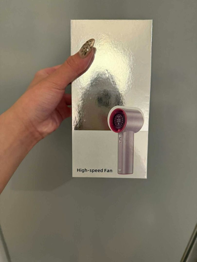 Pink High-Speed Handheld Fan with Display Screen (Category: Fans) located in Manila. Submitted by moond_st (Listing ID 1469718172, Image 2). Description: - Color: Stylish Pink - Battery Capacity: 4000mAh for long-lasting use - Charging: Type-C input (5.0V 2.5A) - Control: Non-polar toggle wheel with a clear digital display screen - Design: Compact size (59x61x160mm) with a handy lanyard eyelet - Inclusion: Comes complete with the original box.