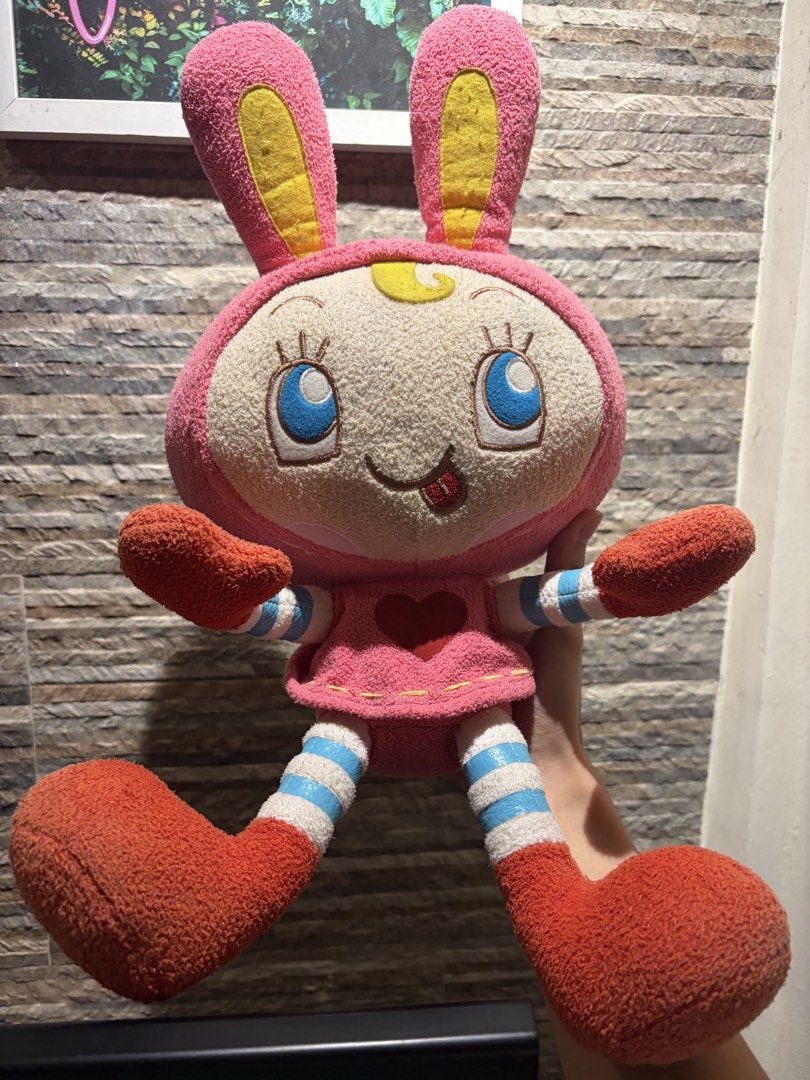 Pink Rabbit Bunny Plush Toy 🧸 (Category: Plushies & Soft Toys) located in Makati City. Submitted by squishycorner (Listing ID 1469713902, Image 1). Description: - Adorable pink rabbit plush featuring big blue eyes - Cute striped limbs and a sweet red heart on the dress - Crafted from soft, huggable textured fabric - Overall clean condition with no major stains - Note: Tag at the back has been cut off.