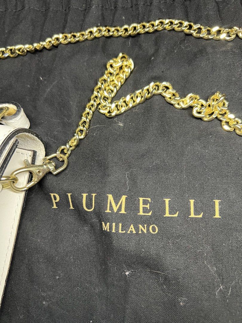 Piumelli Milano leather handbag (Category: Luxury Bags & Wallets) located in General Santos City (Dadiangas). Submitted by queenfinds (Listing ID 1469717953, Image 3). Description: white leather shoulder and crossbody bag featuring a gold-tone metallic brand plaque engraved with PIUMELLI and a gold-tone chain strap. Inclusion: Dust Bag only Loc. General Santos City.