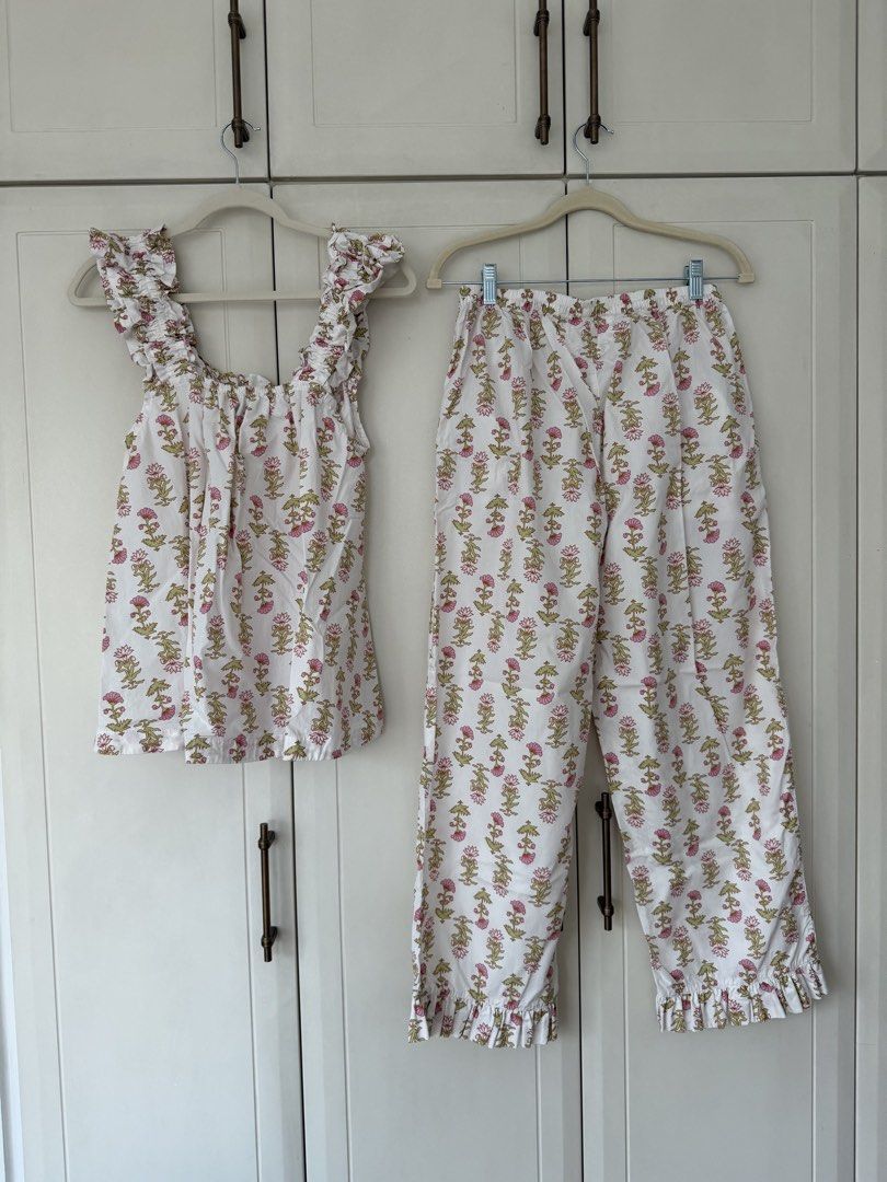 PIYAMA Floral Print Ruffle Pajama Set (Category: Sets or Coordinates) located in Makati City. Submitted by belizalde4 (Listing ID 1469657197, Image 3). Description: - Brand/Item: PIYAMA pajama set - Size: Medium - Design: White with pink and green floral print - Top: Sleeveless, square neckline, ruffled details - Bottoms: Matching pants with ruffle hems, elastic waistband with drawstring .