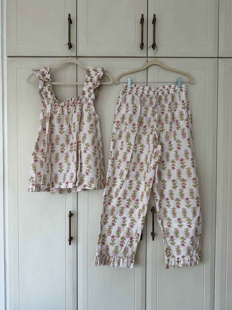 PIYAMA Floral Print Ruffle Pajama Set (Category: Sets or Coordinates) located in Makati City. Submitted by belizalde4 (Listing ID 1469657197, Image 2). Description: - Brand/Item: PIYAMA pajama set - Size: Medium - Design: White with pink and green floral print - Top: Sleeveless, square neckline, ruffled details - Bottoms: Matching pants with ruffle hems, elastic waistband with drawstring .