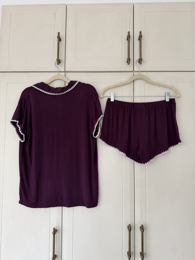 Plum Short Sleeve Pajama Set (Category: Sets or Coordinates) located in Makati City. Submitted by belizalde4 (Listing ID 1469657566, Image 3). Description: - Color: Plum purple with contrasting white scalloped trim - Set includes: Short-sleeve button-up top with chest pocket and matching shorts - Comfort: Elastic waistband on shorts for easy lounging - Material: Super soft, cozy fabric - Details: Chic scalloped edges along the collar, placket, po