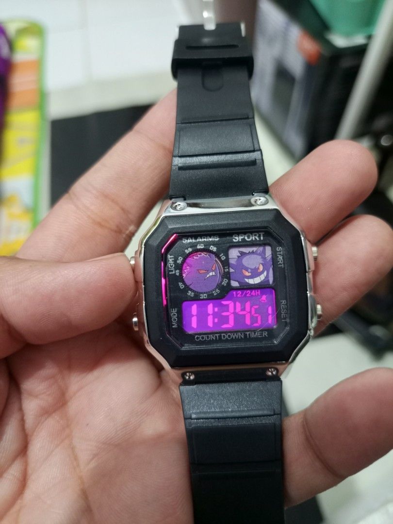 Pokemon Gengar Digital Sport Watch (Category: Men's Watches) located in Manila. Submitted by warmcrystal_269010 (Listing ID 1469702034, Image 3). Description: - Design: Cool Pokémon Gengar graphics on the watch face - Case & Strap: Sleek silver square case with a durable black rubber strap - Features: Built-in countdown timer and multiple alarms - Backlight: Vibrant pink backlight in great working condition - Condition: Excellent, fun accessory f