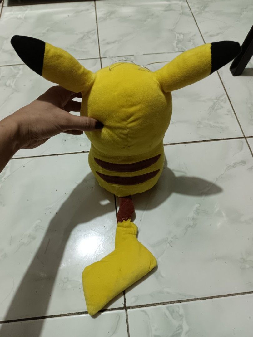 Pokemon Pikachu Plush Toy Winking Face (Category: Plushies & Soft Toys) located in Manila. Submitted by caaths_collection (Listing ID 1469705024, Image 3). Description: - Adorable yellow Pikachu plush doll with a playful winking expression - Features iconic details: red cheeks, black ear tips, back stripes, and lightning bolt tail - Made with ultra-soft, huggable fabric in a charming sitting posture - Standard size, clean and well-maintained - Gr