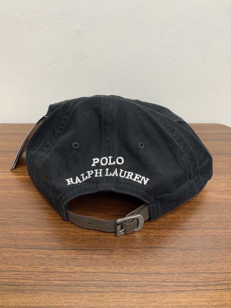 Polo Ralph Lauren Bear Black Cap (Category: Caps & Hats) located in Cavite. Submitted by jeromeaba95864 (Listing ID 1469749877, Image 3). Description: - Authentic Polo Ralph Lauren black baseball cap - Brand new with original tags attached - Iconic embroidered Polo bear on the front - "Polo Ralph Lauren" stitched in white above the back strap - Adjustable brown leather strap with a metal buckle - Features interior blue label and size details.