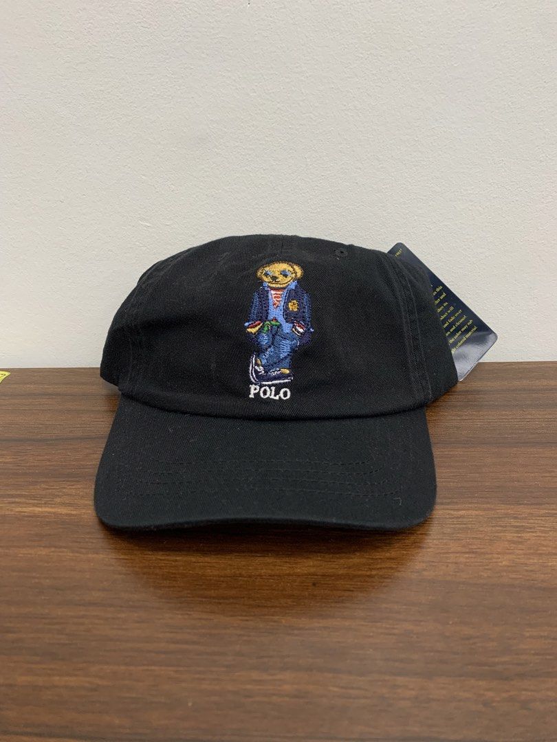 Polo Ralph Lauren Bear Black Cap (Category: Caps & Hats) located in Cavite. Submitted by jeromeaba95864 (Listing ID 1469749877, Image 1). Description: - Authentic Polo Ralph Lauren black baseball cap - Brand new with original tags attached - Iconic embroidered Polo bear on the front - "Polo Ralph Lauren" stitched in white above the back strap - Adjustable brown leather strap with a metal buckle - Features interior blue label and size details.