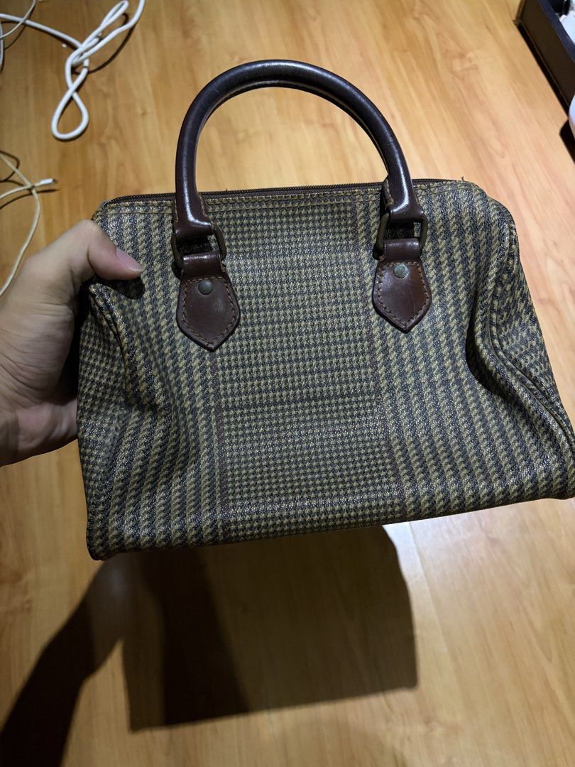 Polo Ralph Lauren Houndstooth Boston Bag (Category: Luxury Bags & Wallets) located in Manila. Submitted by austinver91082 (Listing ID 1469723177, Image 3). Description: RFS: Decluttering - Brand: Polo Ralph Lauren - Style: Boston bag / Handbag - Pattern: Brown and black houndstooth - Material: Sturdy dark brown leather handles and trim - Closure: Zip-top - Details: Signature metal logo plaque on the front - Condition: Vintage charm with minor sig