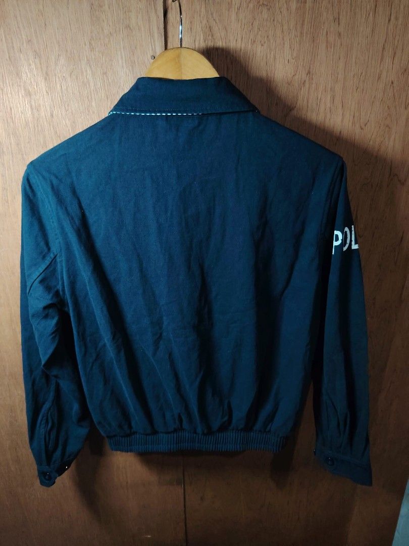 Polo Ralph Lauren Navy Cotton Jacket (Category: Coats, Jackets and Outerwear) located in Baguio. Submitted by tabuzomaria1422 (Listing ID 1469701705, Image 2). Description: - Brand: Polo Ralph Lauren - Color: Dark Blue - Material: 100% Cotton (Made in China) - Design: Full zip front, side pockets, elasticized hem, and button cuffs - Details: White embroidered Polo logo on left chest, large 'POLO' print on right sleeve, and stylish striped pattern