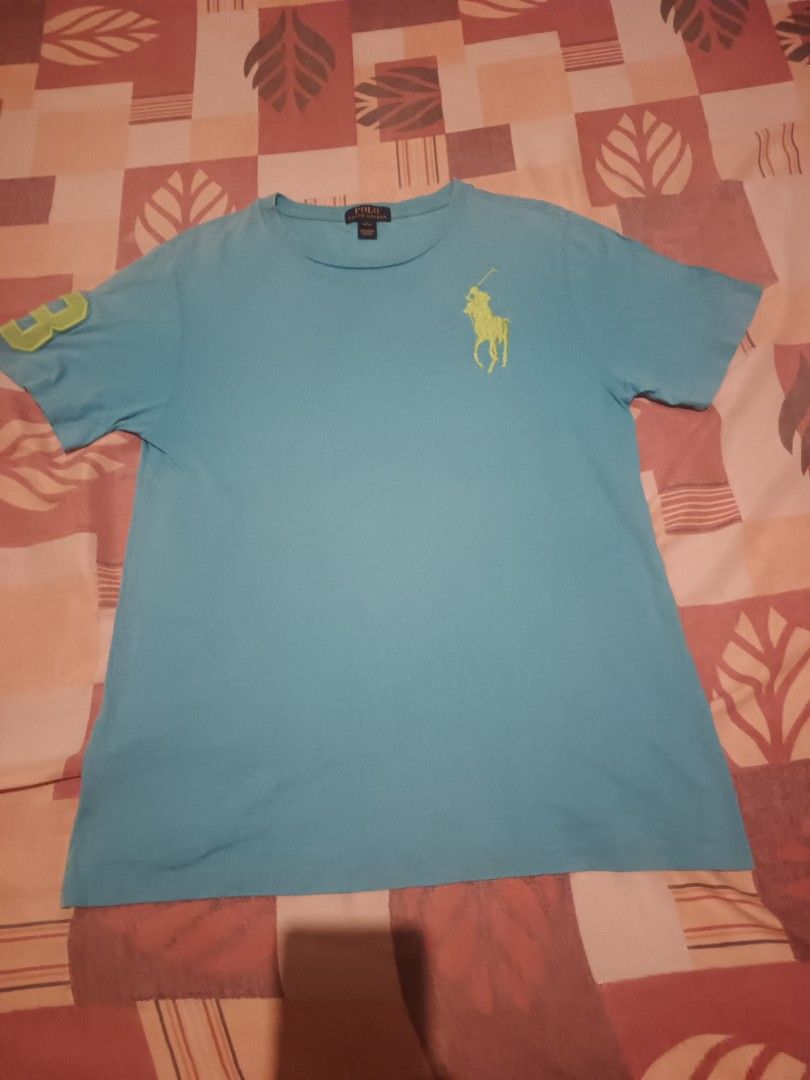 Polo Ralph Lauren tshirt (Category: Activewear) located in Odiongan. Submitted by thriftngo26 (Listing ID 1469581174, Image 1). Description: This is a turquoise blue Polo Ralph Lauren short-sleeve t-shirt featuring a lime-green embroidered Big Pony logo on the chest and the number "3" appliqué on the sleeve.
