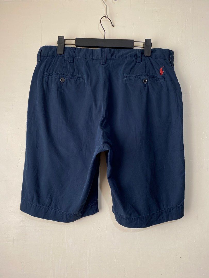 POLO RALPH LAUREN,Chino short (Category: Shorts) located in Cavite. Submitted by jc_thrift95 (Listing ID 1469655334, Image 2). Description: - a pair of navy blue men’s chino shorts by Polo Ralph Lauren, featuring a red embroidered pony logo above the back pocket. - Made in Sri lanka - L- 20 inch - W- 18 inch - Color rate 8/10 - See picture details for dimes. .