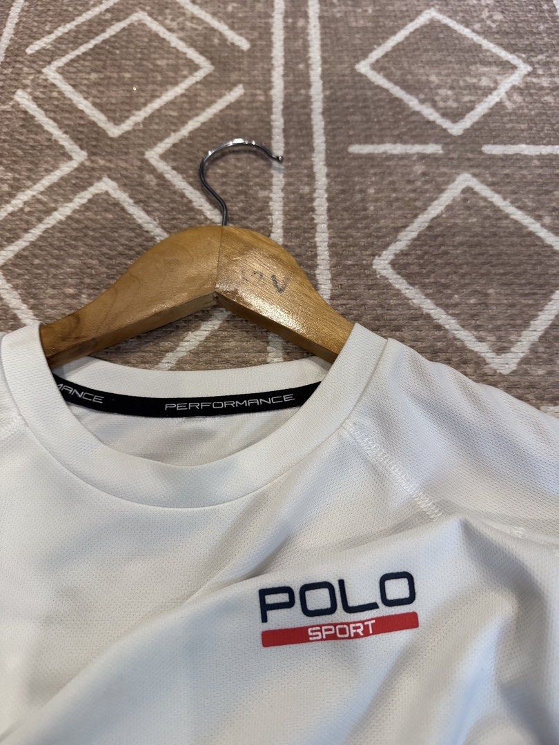 Polo Sport Performance White T-Shirt (Category: Tshirts & Polo Shirts ) located in Bulacan. Submitted by zyannechlo86360 (Listing ID 1469646771, Image 3). Description: - Brand/Model: Polo Sport performance t-shirt - Color: White - Material: Breathable athletic fabric - Features: Short sleeves, logo on left chest, small logo tag near bottom hem, and performance neck tape inside collar - Condition: Great for workouts or casual daily wear.