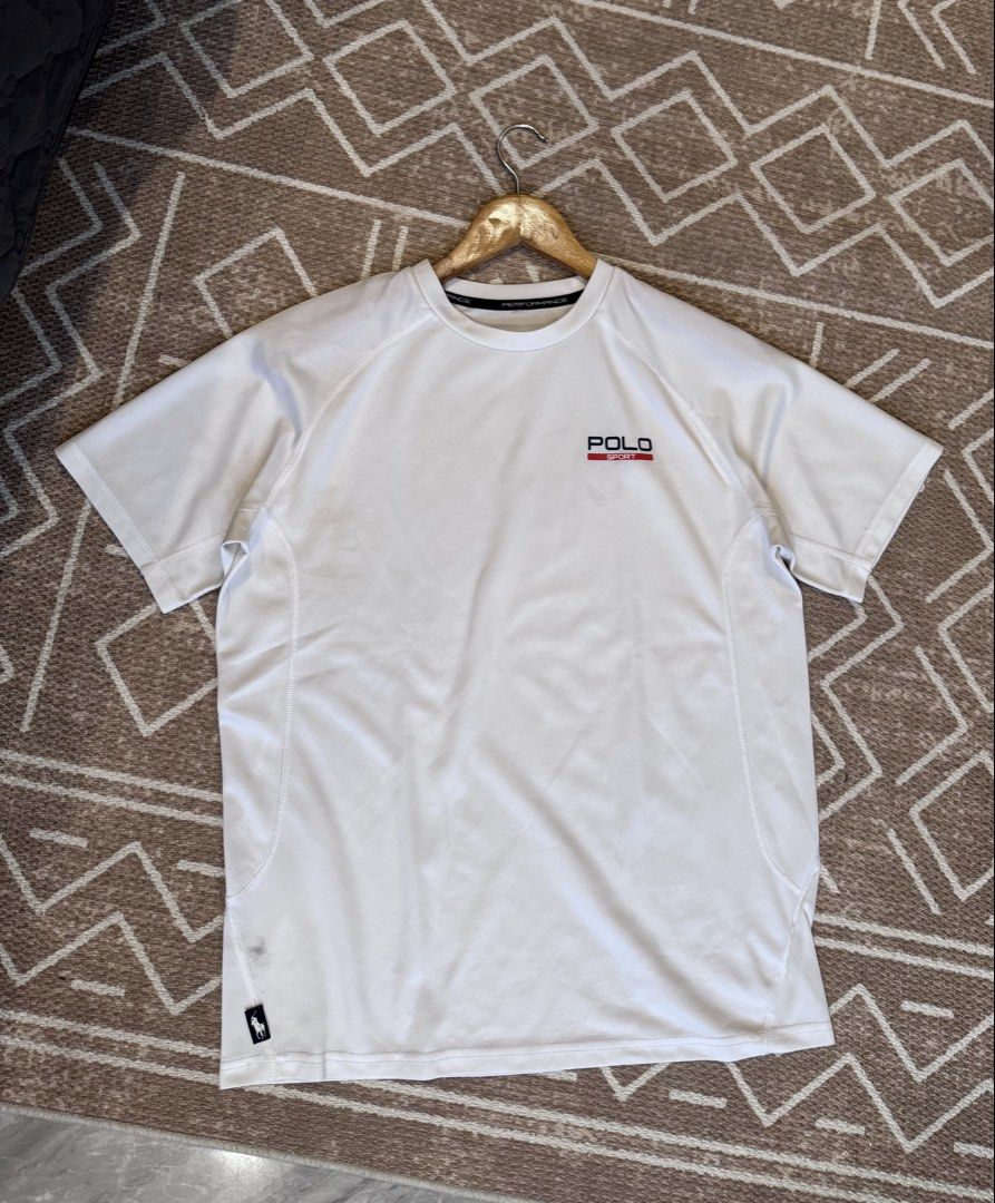 Polo Sport Performance White T-Shirt (Category: Tshirts & Polo Shirts ) located in Bulacan. Submitted by zyannechlo86360 (Listing ID 1469646771, Image 1). Description: - Brand/Model: Polo Sport performance t-shirt - Color: White - Material: Breathable athletic fabric - Features: Short sleeves, logo on left chest, small logo tag near bottom hem, and performance neck tape inside collar - Condition: Great for workouts or casual daily wear.