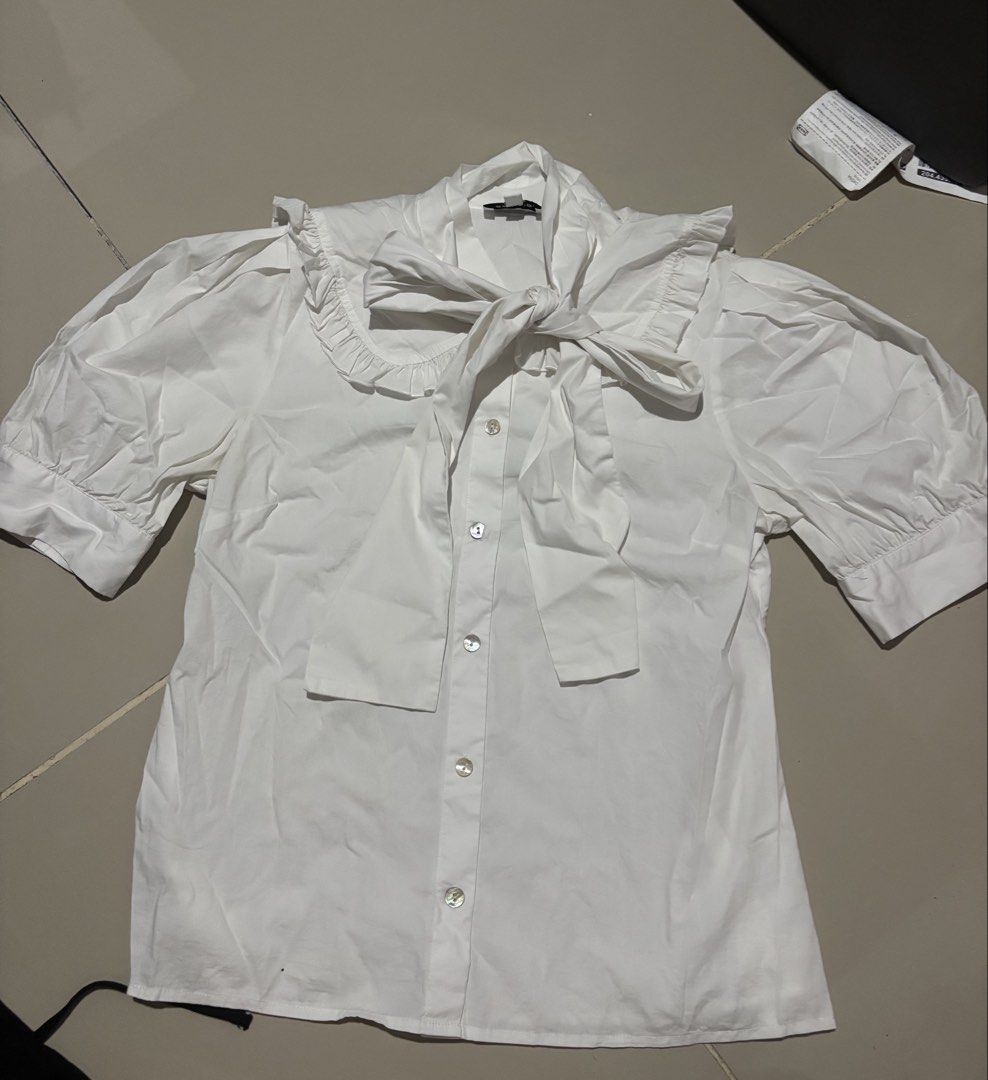 Pomelo White Ruffle Collar Bow Blouse (Category: Blouses) located in Manila. Submitted by matchalatte.2 (Listing ID 1469625917, Image 1). Description: - Brand: Pomelo - Color: White - Size: Small - Style: Button-down blouse - Details: Short puff sleeves with banded cuffs, large ruffled collar, and attached front ribbon tie - Condition: Excellent / Like new - Perfect for: Office wear, casual outings, or date nights.