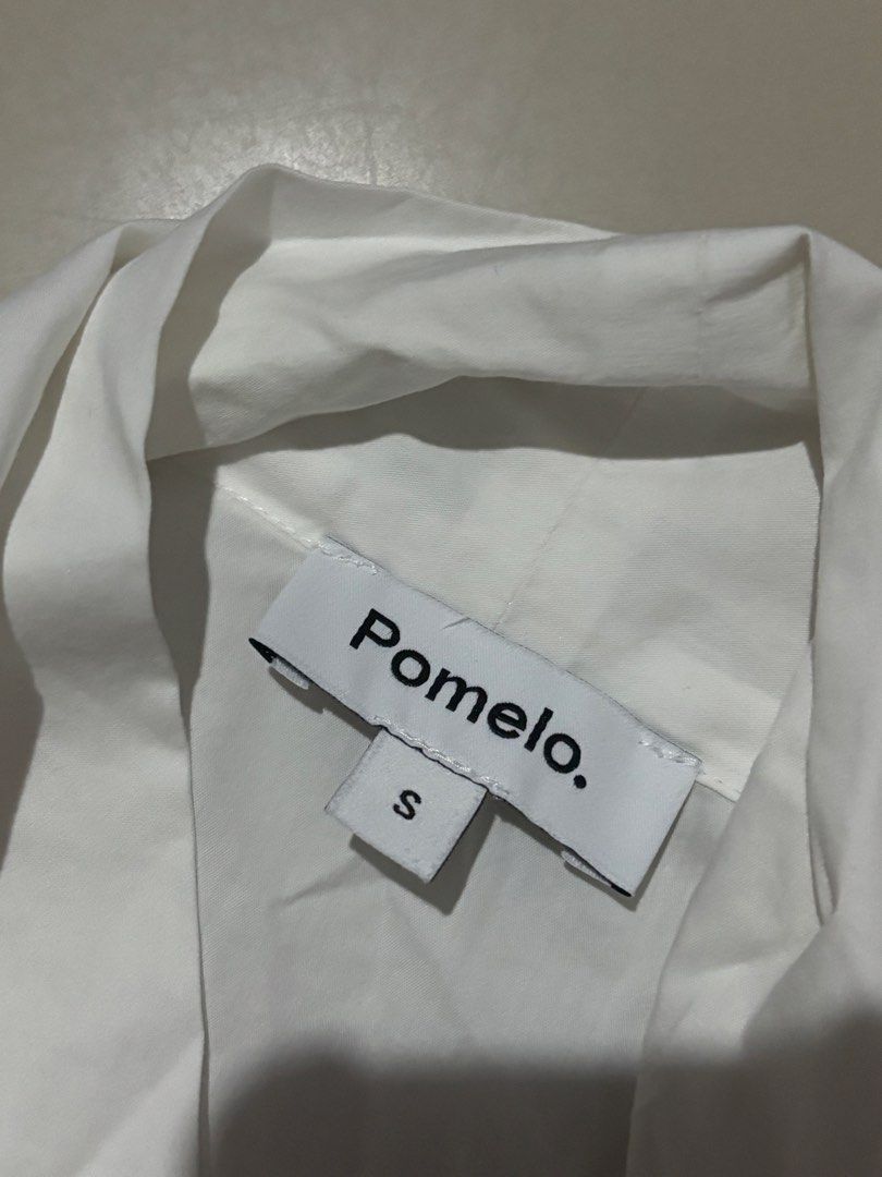 Pomelo White Ruffle Collar Bow Blouse (Category: Blouses) located in Manila. Submitted by matchalatte.2 (Listing ID 1469625917, Image 2). Description: - Brand: Pomelo - Color: White - Size: Small - Style: Button-down blouse - Details: Short puff sleeves with banded cuffs, large ruffled collar, and attached front ribbon tie - Condition: Excellent / Like new - Perfect for: Office wear, casual outings, or date nights.